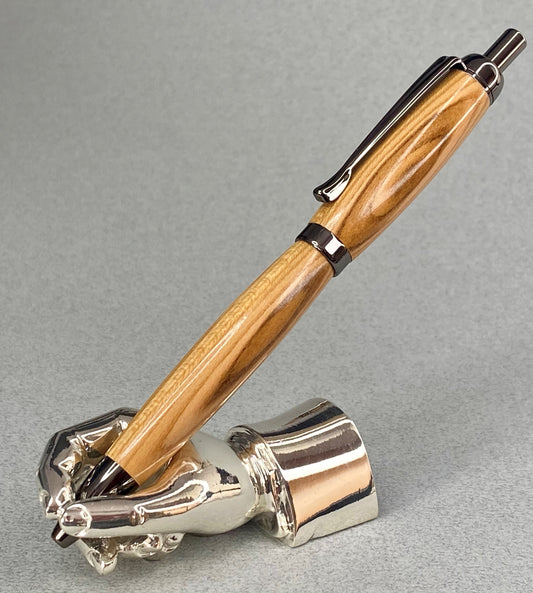 A right hand shaped metal base shown holding a handturned Almond wood pen as you would hold it to write with.