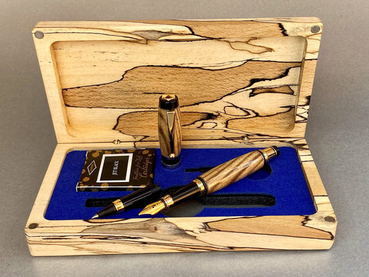 Spalted Beech wood hand crafted presentation box with its lid open showing one hand turned hand crafted pen made from Black Ash Wood, It has Gold Plated fittings and black accents on the nib, there is a second nib in the box that is a rollerball type so you can switch between the two. 
