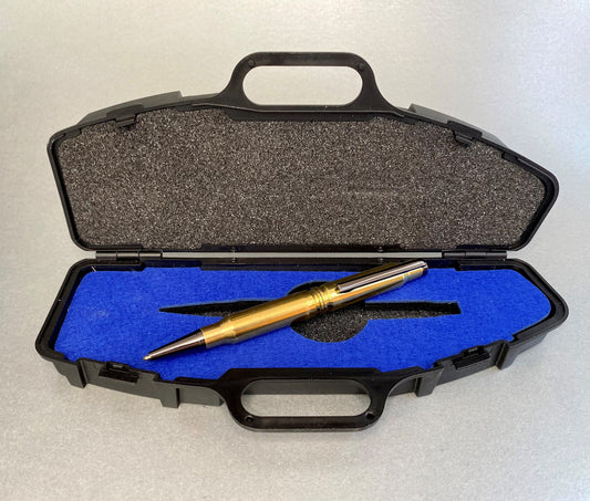 Open pen sized plastic rifle case showing a hand made pen sitting inside that has been made from recycled 308 once fired shells.