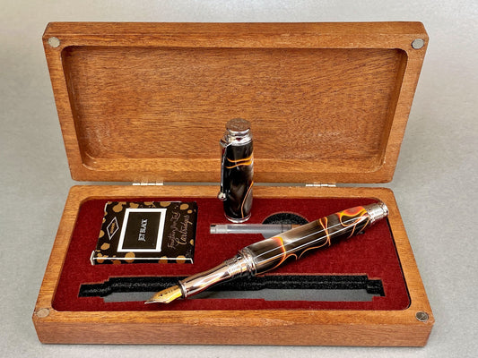Open lidded Mahogany wood box displaying a hand made Acrylic fountain pen with a wine coloured laser cut insert