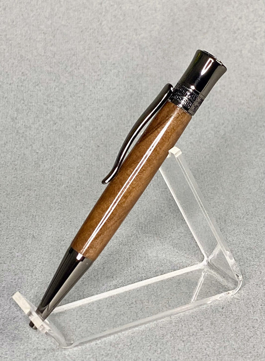 A clear acrylic stand holding a handturned Pistachio Bolt action pen.