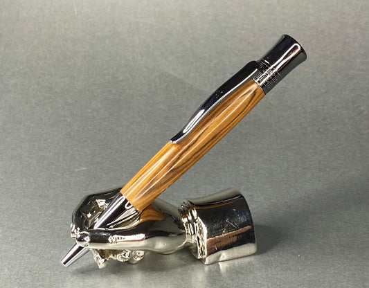 A right hand shaped metal base holding a handturned Olive Wood pen as you would hold it to write with.